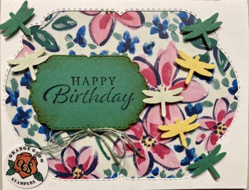 Bright floral DSP under die cut label and lots of dragonflies