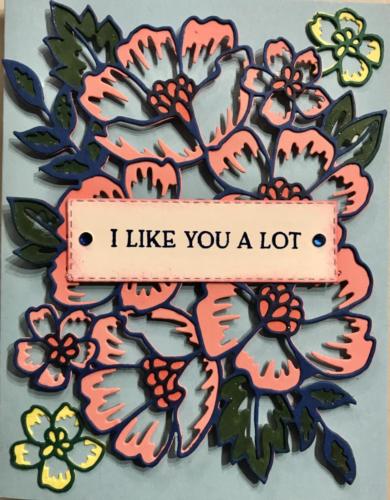 Blue die cut border, pink florals, added yellow and blends of green, and flamingo