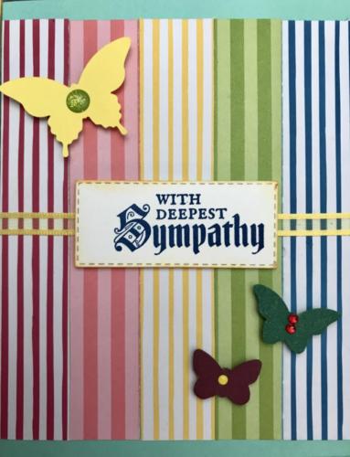 Sympathy card with yellow ribbon adds a sombre touch.